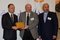 Dr. Abed Amin Yakan, Jinan University (JU) President, receiving shield of appreciation